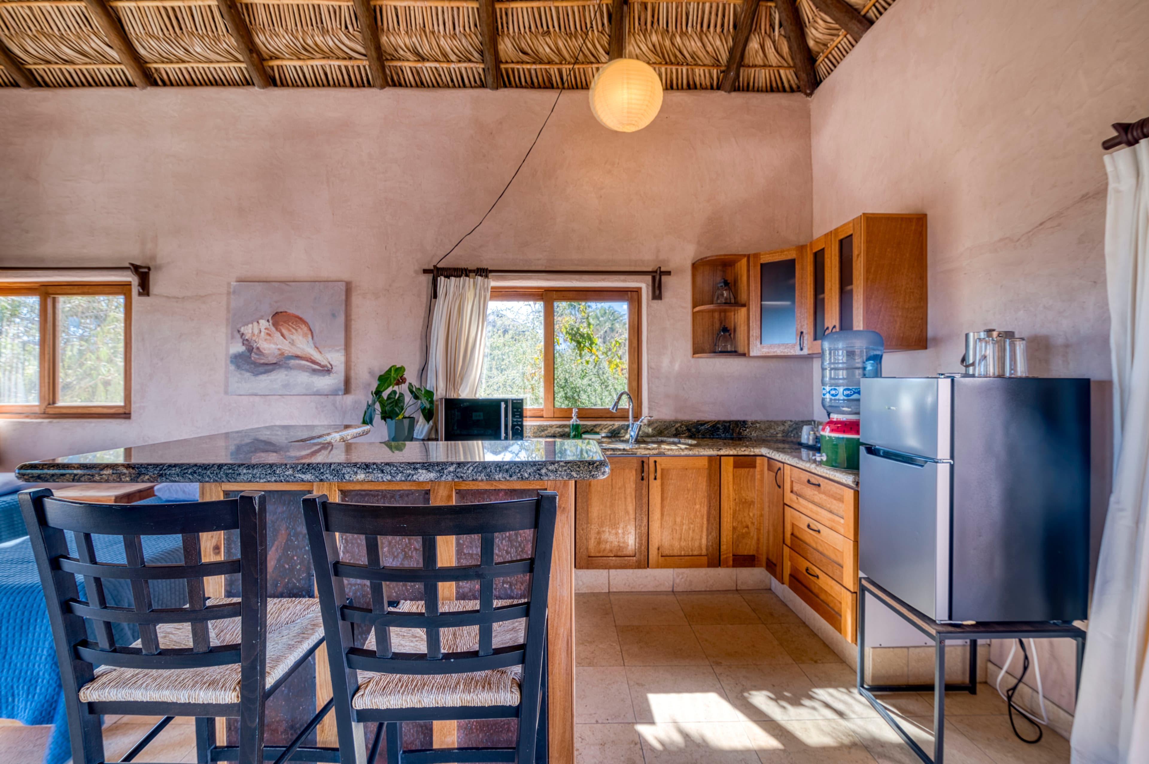 Bright, modern kitchen with wooden cabinets, a granite countertop, and natural light.