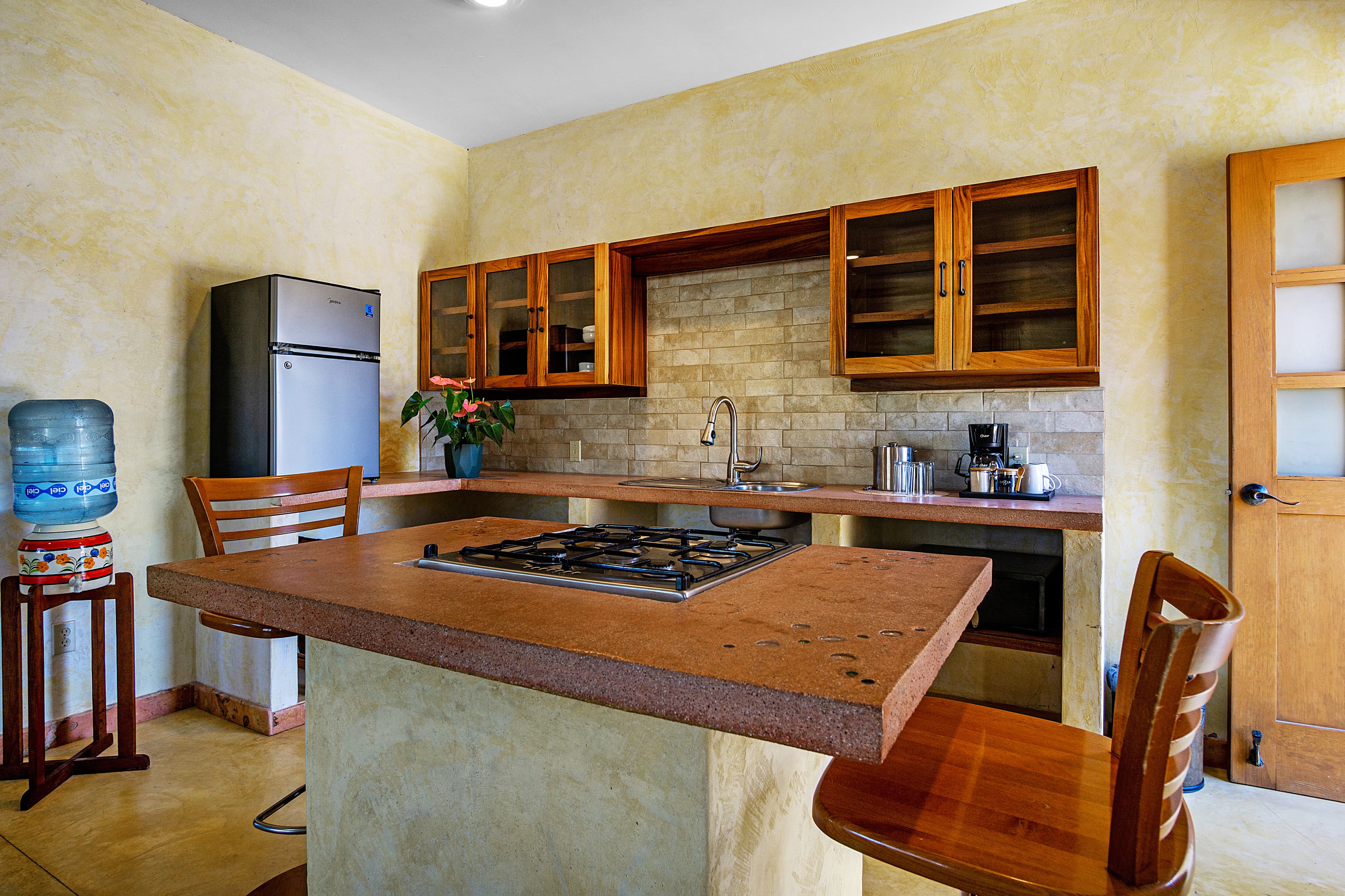 Modern kitchen with wooden cabinets, a gas stove, and a refrigerator.